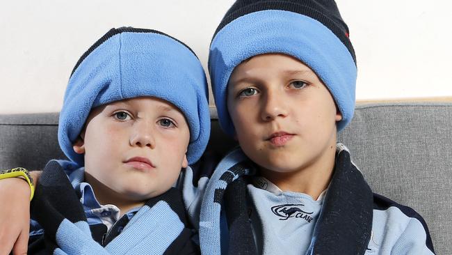 Charlie, 6, and Thomas Gilfillan, 9, were abused for wearing Blues gear at Wednesday’s Origin match at Suncorp Stadium. Picture: AAP/Josh Woning