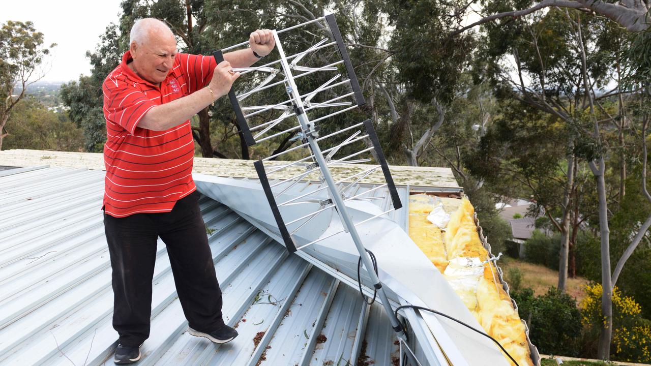 Damaging winds, showers and thunderstorms have hit across South Australia, Monday, October 15, 2018. Mario Petruzzelli of Mitcham on his damaged roof. (AAP Image/ Brenton Edwards)