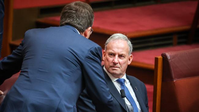 Senator Richard Colbeck (R), Minister for Aged Care and Senior Australians, talks with a fellow Senator as he sits in the Australian Senate at Parliament House on September 3, 2020 in Canberra, Australia. The federal aged care royal commission has criticised the Morrison government for failing to establish independent monitoring and reporting of aged care quality outcomes during the coronavirus pandemic. (Photo by David Gray/Getty Images)