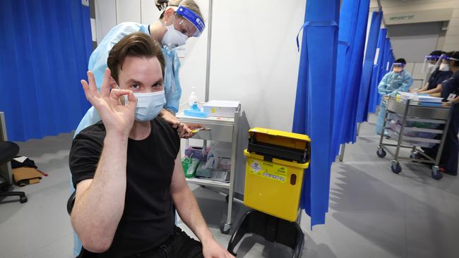 Anthony Naus 30, gets his AstraZeneca vaccination at the Melbourne Convention and Exhibition Centre. Picture: David Caird