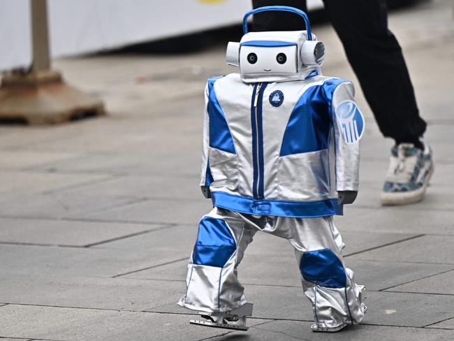 A robot takes part in the humanoid robot half marathon in Beijing on April 19, 2025. Dozens of humanoid robots took to the streets of Beijing, joining thousands of their flesh-and-blood counterparts in a world-first half marathon showcasing China's drive to lead the global race in cutting-edge technology. (Photo by Pedro Pardo / AFP)