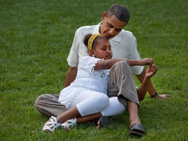 President Barack Obama sits with daughter Sasha during a barbecue with family and friends in celebration of his 49th birthday on the South Lawn of the White House, Aug. 8, 2010. Picture: Official White House Photo by Pete Souza