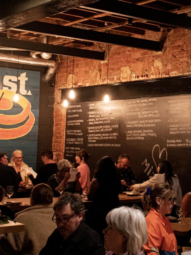 The menu board and exposed rafters of Peel St Restaurant.