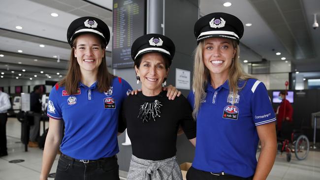 AFLW players Isabel Huntington of the Bulldogs and Kaitlyn Ashmore of the Kangaroos with Virgin CEO Jayne Hrdlicka. The ACCC says Virgin’s shift to the mid-market may make life easier for both Qantas and Jetstar. Picture: Supplied.