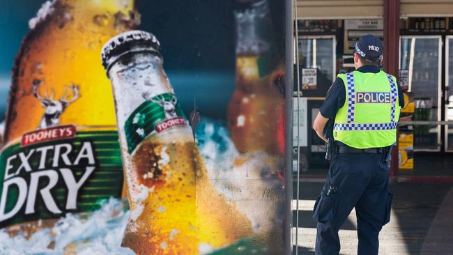 A NT Police point of sale intervention officer outside an Alice Springs bottle shop.