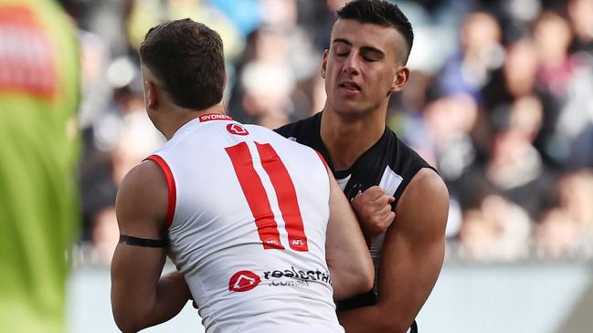 Sydney’s Tom Papley tries to rough up Nick Daicos. Picture: Michael Klein