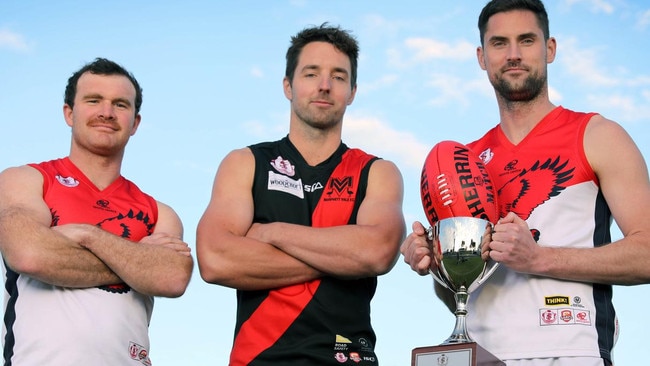 Morphett Vale star Michael Smith (middle) with Flagstaff Hill champions Michael Shearer (left) and David Kearsley. Picture: Dean Martin