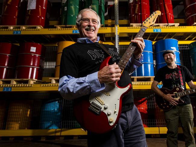 Royal Australian Mint CEO Ross MacDiarmid (l) and General Manager Mark Cartwright pay homage to AC/DC due to the release of a new coin set celebrating the anniversaries of 6 electrifying AC/DC albums. The pair are pictured on the floor of the mint where the coins are pressed. The drums behind them are full of different coin denominations. Picture by Sean Davey.