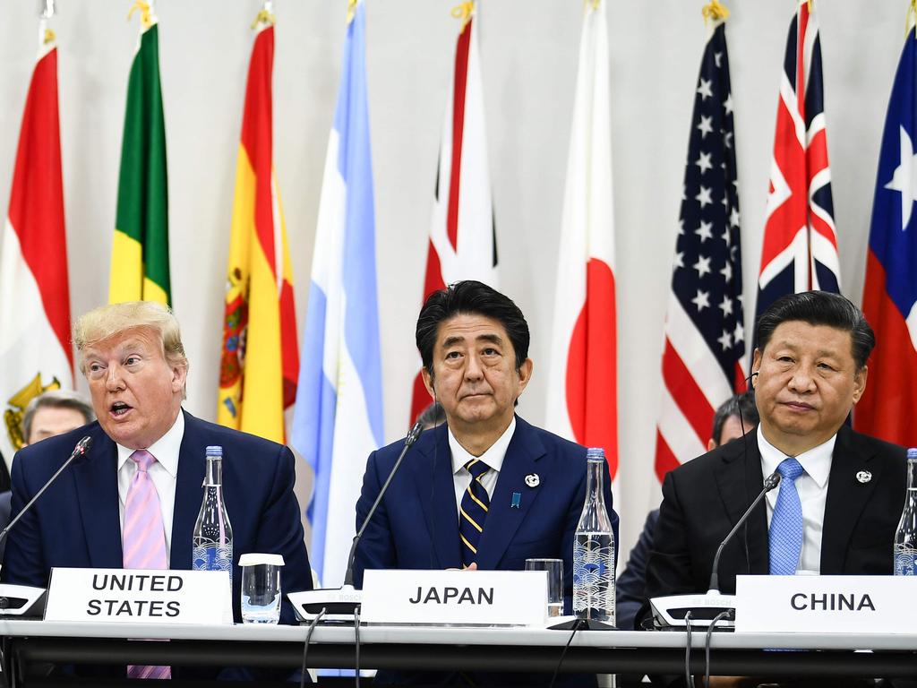 Japan's Prime Minister Shinzo Abe was deliberately placed between US President Trump and China's Xi Jinping.