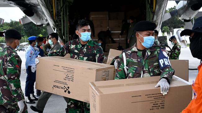 Indonesian troops unload protective gear at Denpasar, Bali, on Friday. Picture: AFP