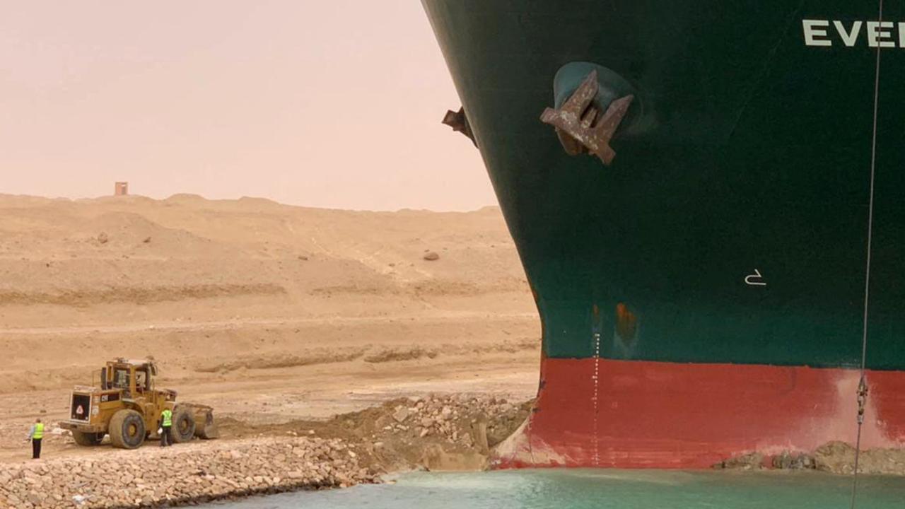 Bulldozers helping to shift sand and soil from around the vessel. Picture: Suez Canal Authority.