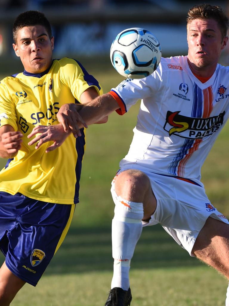 United's Can Cuba and Lions’ Chris Hatfield jostle for the ball. Picture: Steve Holland