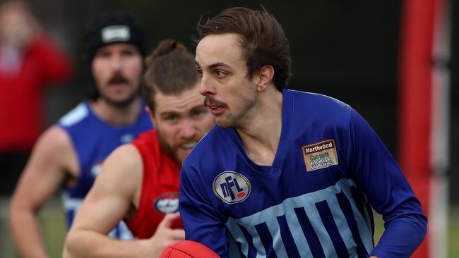 Lachlan Shaw of Reservoir runs the ball out of the back line during the NFL football match between Lalor and Reservoir played at Lalor Reserve on Saturday 7th July, 2018.