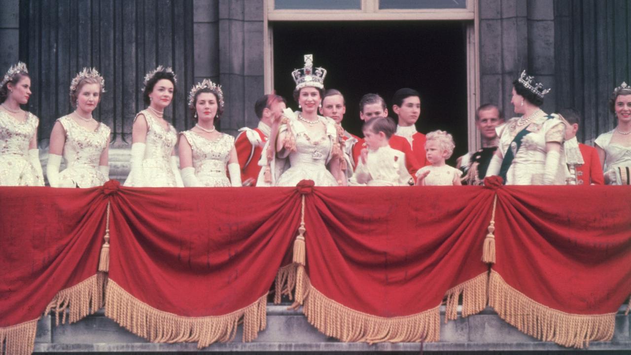 After a two-hour journey back to Buckingham Palace, the Queen greeted cheering crowds from the balcony with her children Prince Charles and Princess Anne by her side. Picture: Hulton Archive/Getty