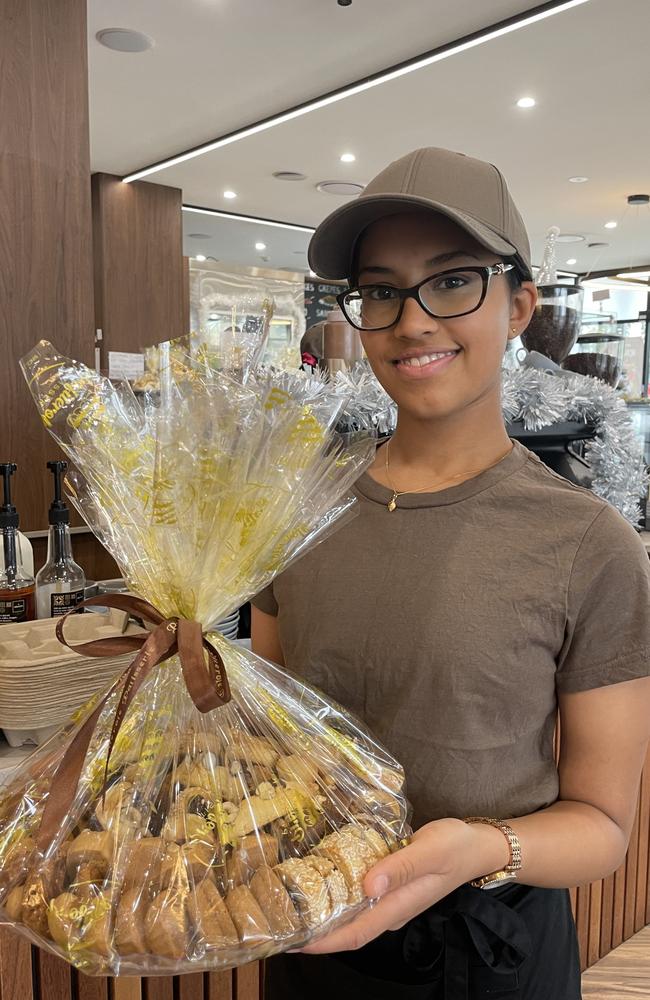 Profiterole Patisserie Mays Hill employee Sahanna Sri with a mixed biscuit plate.