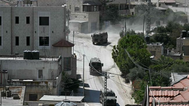 Israeli armoured vehicles drive in a street during an army raid in Jenin in the occupied-West Bank on August 31. Picture: AFP