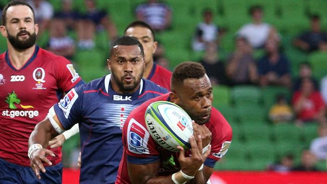 Eto Nabuli of the Reds takes the ball in front of Sefa Naivalu of the Rebels during the round 2 Super Rugby match between the Melbourne Rebels and the Queensland Reds at AAMI Park in Melbourne, Friday, February 23, 2018. (AAP Image/Hamish Blair) NO ARCHIVING, EDITORIAL USE ONLY