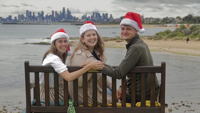 British tourists Sophie Foreman, Kristy Merganovski and Cameron Garrett at Melbourne’s Brighton Beach. Picture: Valeriu Campan