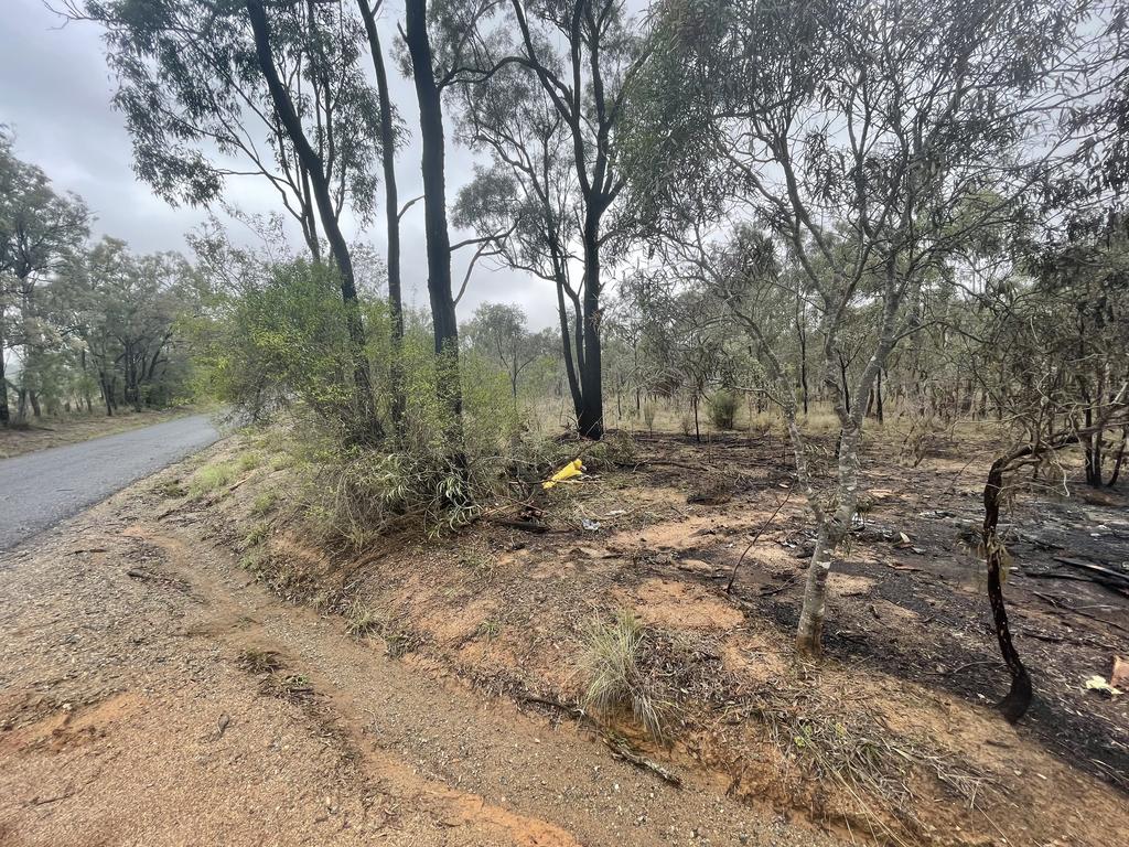 Debris from a yellow car remains scattered on burnt ground at Washpool Rd, near Leslie Dam. November 12, 2024.