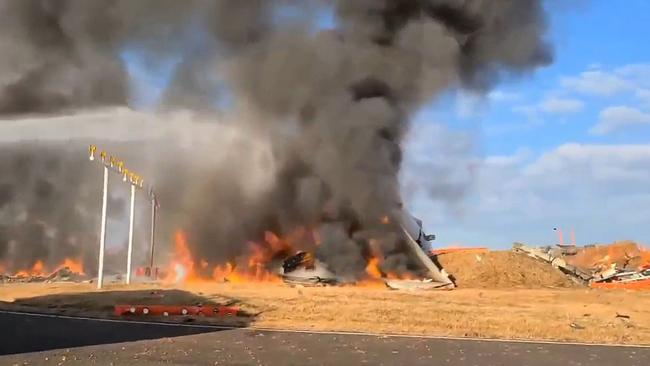 The burning wreckage of the aircraft. Picture: YONHAP / AFP