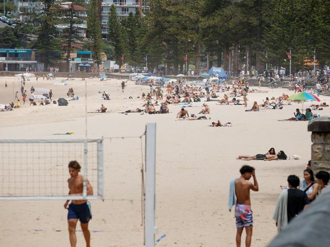 Beachgoers were still at Manly Beach on Tuesday afternoon despite authorities closing the beach and urging people to stay away. Picture: NewsWire / Nikki Short