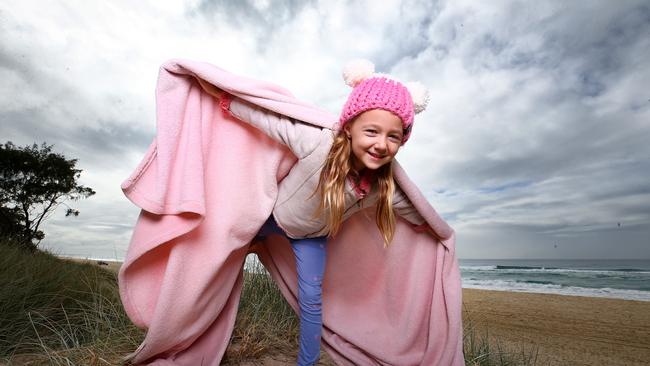 Zali Ledek, 6, rugs up on the Gold Coast for the cold weather that's about to hit. Picture: Adam Head