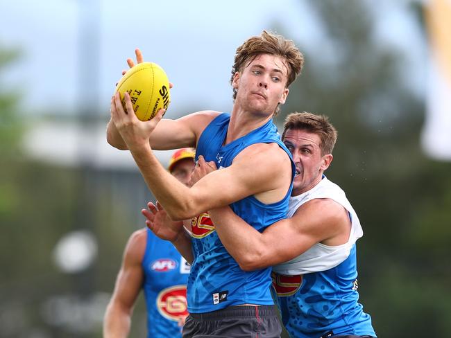 GOLD COAST, AUSTRALIA - FEBRUARY 27: Ethan Read is tackled by g24=during a Gold Coast Suns AFL training session at Austworld Centre Oval on February 27, 2024 in Gold Coast, Australia. (Photo by Chris Hyde/Getty Images)