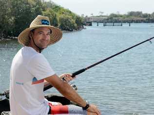 Brisbane boy Josh Murray enjoys a spot of fishing away from the Coolangatta crowds at Jack Evans boat harbour. Photo: Blainey Woodham / Daily News. Picture: Blainey Woodham