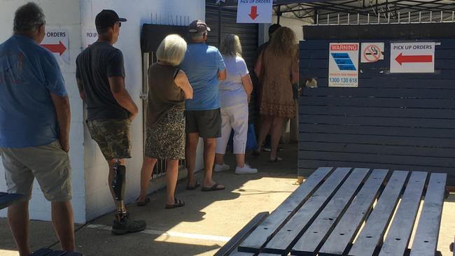 People queue to collect their orders at the Coffs Harbour Fishermen's Co-operative on Christmas Eve.