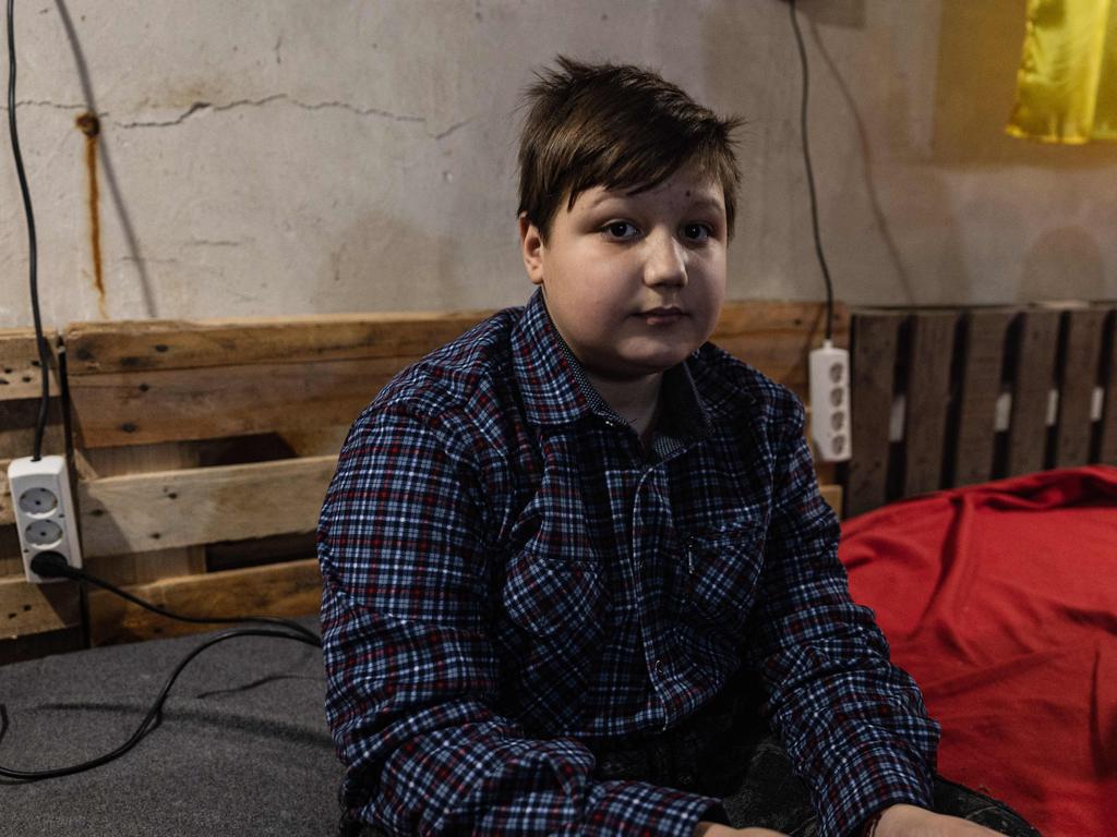 Volodymyr, 12-year-old, looks on as he is playing with his phone in a basement in the city of Bakhmut, eastern Ukraine. Picture: AFP