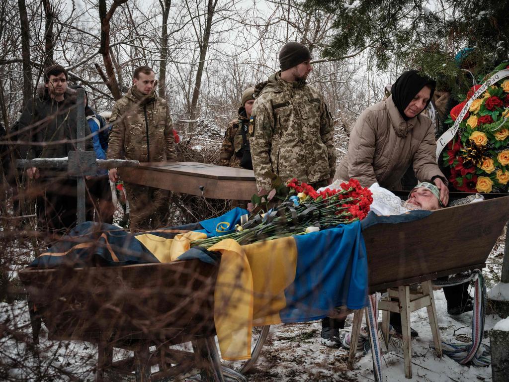 Natalia Shalashnaya (R), 52, mourns over the casket of the late Ukrainian serviceman of the Azov battalion killed in action in Bakhmut, 28-year-old orphan Oleksandr Korovniy. Picture: AFP