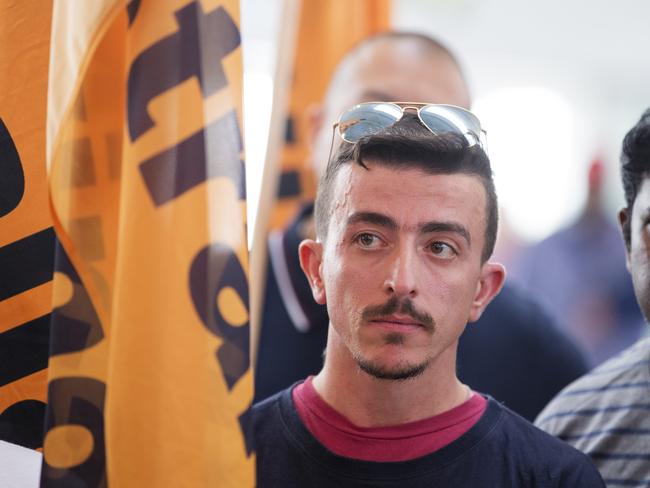 Airport workers hold protests at all Sydney Domestic Airport  over attempts to introduce split shifts across the industry. Airport worker Theo Seremetidis looks on as Shane OÕBrien (Transport Workers Union) national aviation gives a speech.  director Pic Jenny Evans