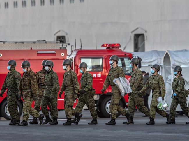 Members of Japan’s self-defence force walk from the Diamond Princess cruise ship. Picture: Getty