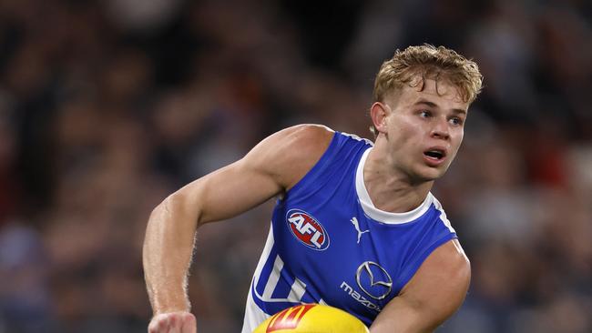 MELBOURNE, AUSTRALIA - JULY 21:  Jackson Archer of the Kangaroos handballs during the round 19 AFL match between Carlton Blues and North Melbourne Kangaroos at Marvel Stadium, on July 21, 2024, in Melbourne, Australia. (Photo by Darrian Traynor/Getty Images)