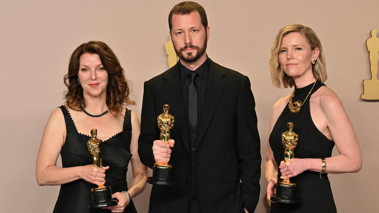 Ukrainians filmmaker Mstyslav Chernov (centre), Raney Aronson-Rath and Michelle Mizner won the Oscar for Best Documentary Feature for 20 Days in Mariupol at the 96th Annual Academy Awards. Picture: AFP