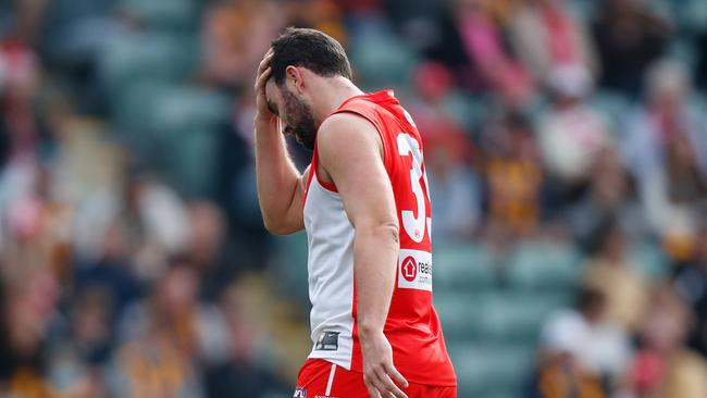 Paddy McCartin holds his head after a collision against Hawthorn. (Photo by Michael Willson/AFL Photos via Getty Images)