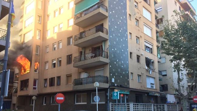 Flames can be seen pouring out of the second storey of the block of units in Premia de Mar, north east of Barcelona, which have had to be evacuated. Picture: Twitter / 324