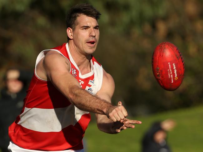 Glenroy’s Travis Dulic fires off a handball on Saturday. Picture: Hamish Blair