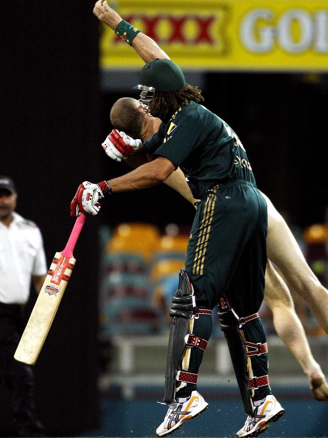 05/03/2008 WIRE: (FILES) This photo taken on March 4, 2008 shows Australian cricketer Andrew Symonds (front) clashing with streaker Robert Ogilvie (back) during the second final in the one-day triangular series cricket match in Brisbane. Ogilvie who appeared at the Brisbane Magistrates Court on March 5, 2008 insisted he had no regrets about his on-field romp, saying it was "great" when burly Australian all rounder Andrew Symonds smashed him to the turf of Brisbane's Gabba ground with a shoulder charge. 26-year-old Ogilvie was handed a 1,500 dollar (1,395 USD) fine but escaped having a conviction recorded against him after pleading guilty to willful exposure. AFP PHOTO/Greg WOOD