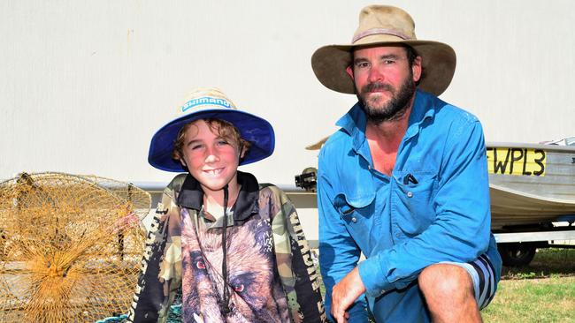 Burdekin father of three and commercial crabber Will Pearce with son Casey (left). Mr Pearce says he will be forced out of the industry by catch allocations.