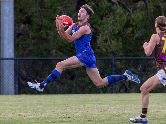 Peninsula's Tom “Flying” Feldgen takes a mark at full stretch. Picture: Pearcey Presents