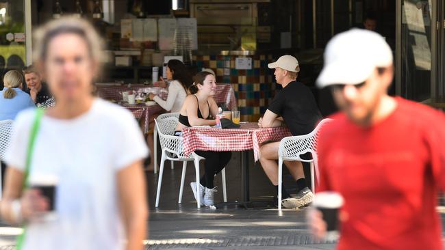 Cafe customers sit at tables distanced from each other in South Bank. (AAP Image/Dan Peled)