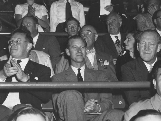 Prince Philip was an enthusiastic spectator at the Olympic Pool during the 1956 Olympic Games. Seated between the arena manager, Mr W. Berge Phillips (left) and Prince Axel of Denmark (right).