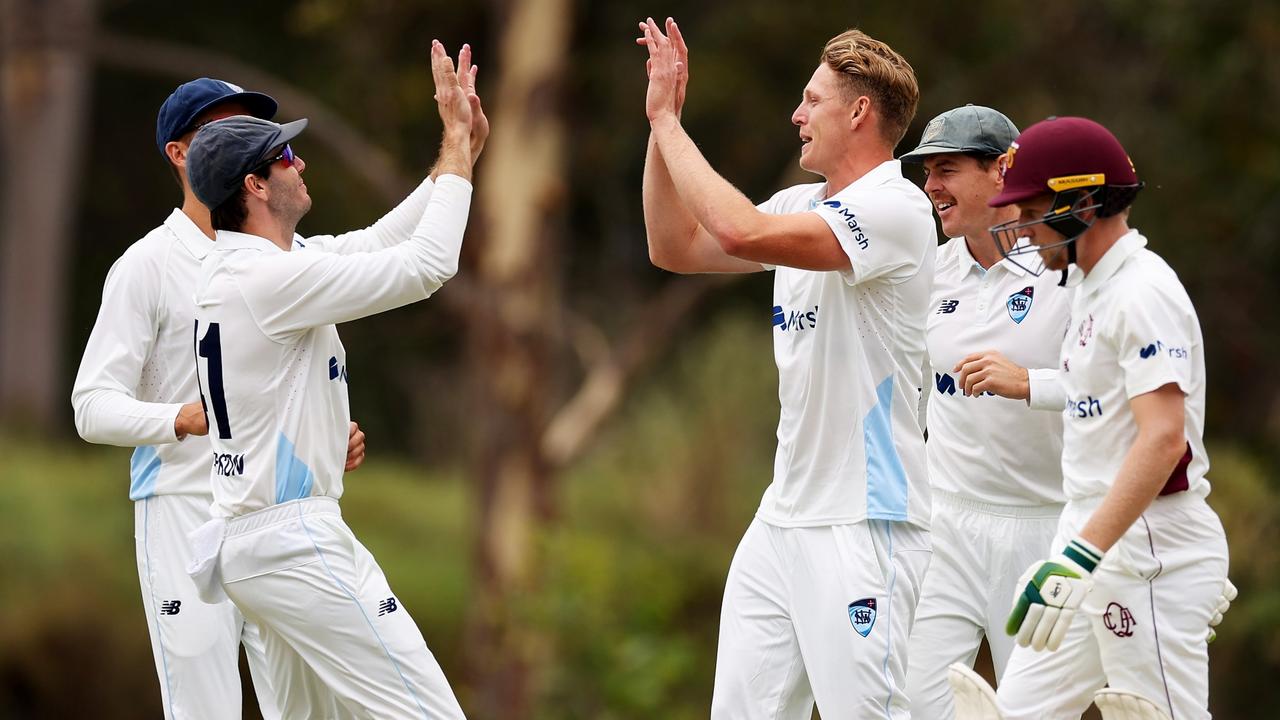 NSW teammates celebrate with Jack Edwards (third from right) after one of his five wickets on the opening day of the Sheffield Shield match against Queensland at Sydney Olympic Park. Picture: Matt King / Getty Images