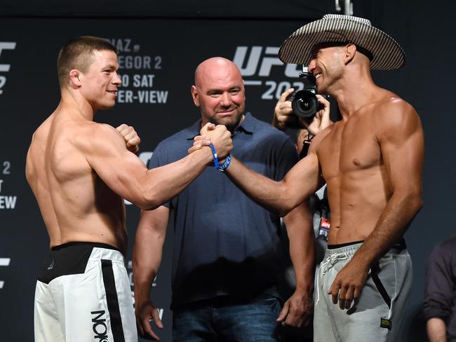 Rick Story (L) and Donald Cerrone shake hands as they face off during their weigh-in for UFC 202.