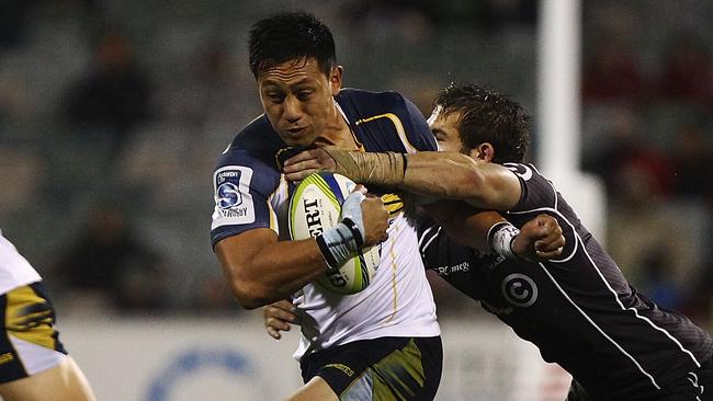 CANBERRA, AUSTRALIA - MAY 10: Christian Lealiifano of the Brumbies is tackled during the round 13 Super Rugby match between the Brumbies and the Sharks at Canberra Stadium on May 10, 2014 in Canberra, Australia. (Photo by Stefan Postles/Getty Images)