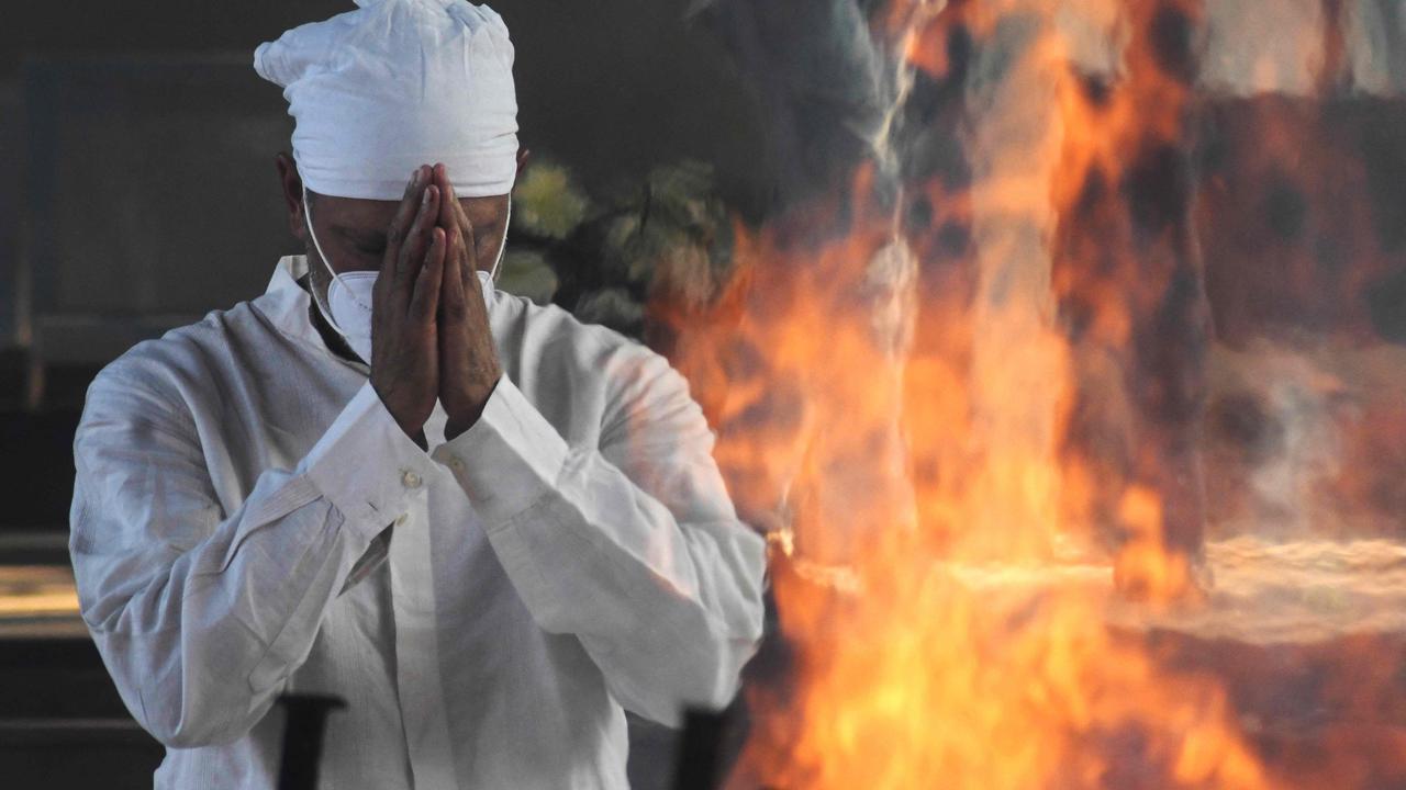 Golfer Jeev Milkha in front of the funeral pyre of his dad Milkha Singh. Picture: AFP