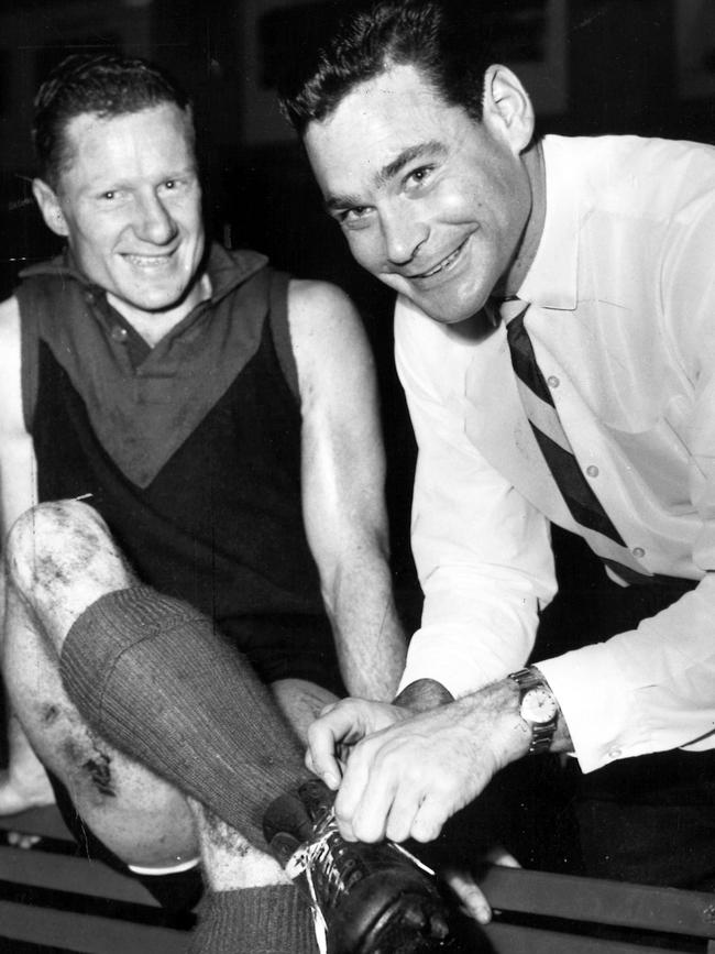 Barassi with Demons player Frank Bluey Adams in 1964.