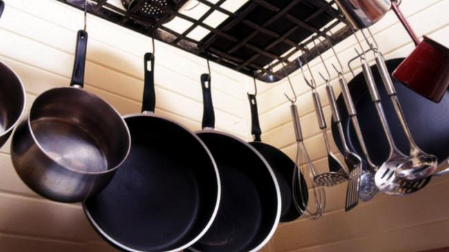 Hanging pots and pans and kitchen utensils make for a streamlined household.