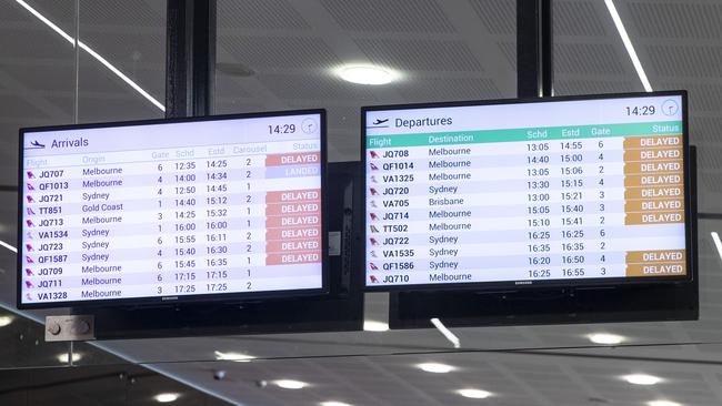 The arrivals and departures boards at Hobart Airport at 2.30pm. Picture: LUKE BOWDEN